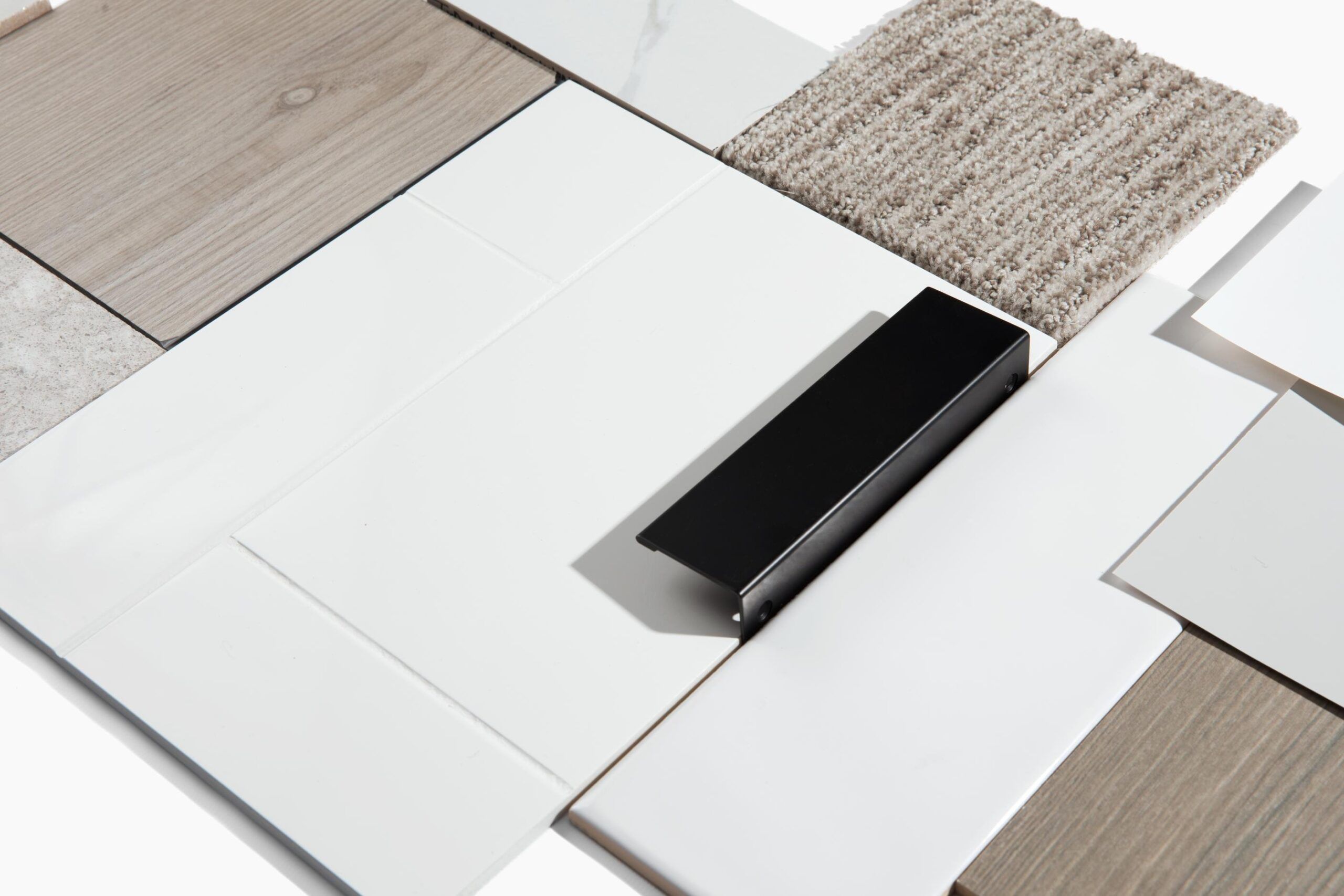 Landmark Tower A selection of various tiles and carpet samples arranged in a geometric pattern on a white background.