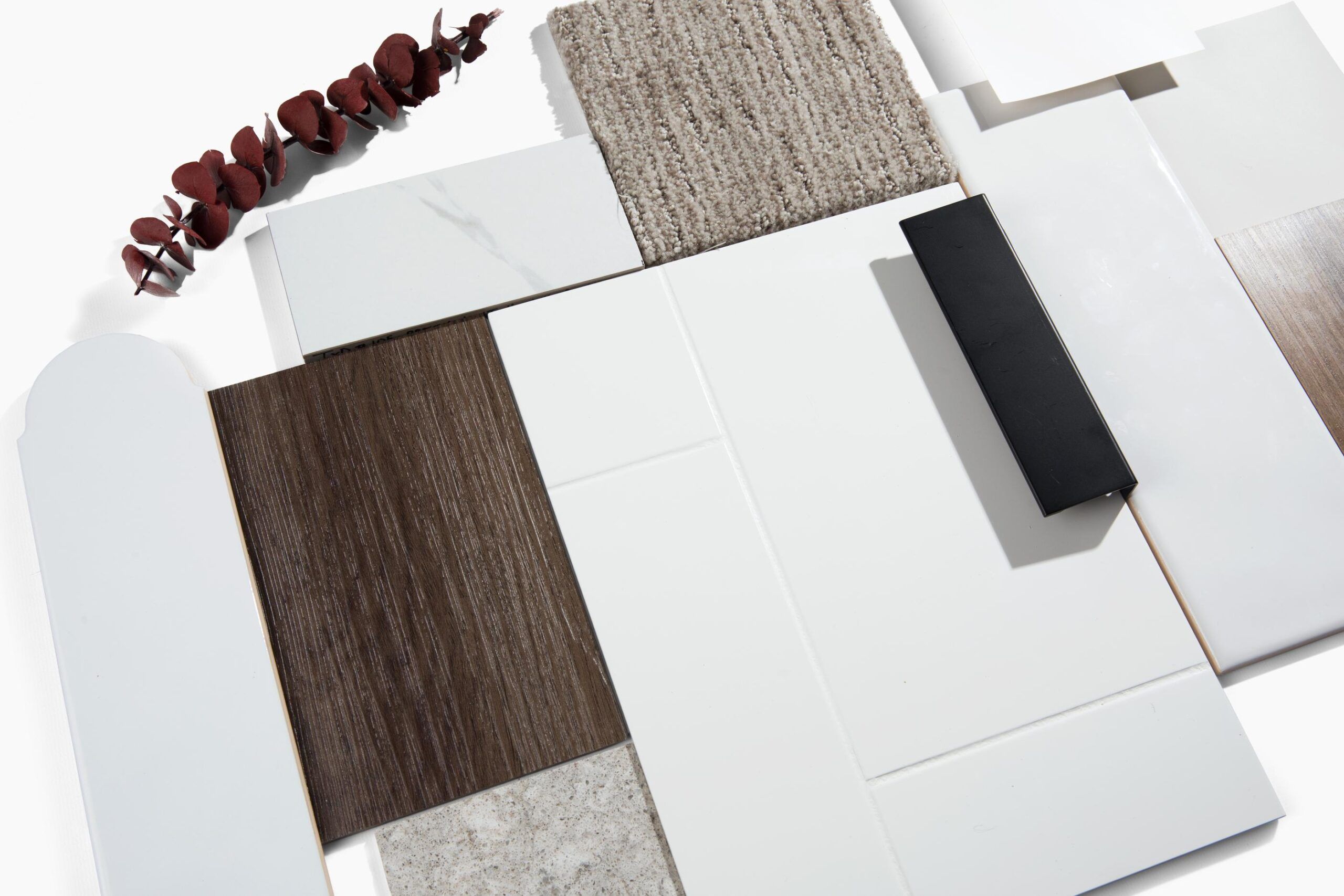Landmark Tower A variety of tiles in different textures and colors arranged on a surface with a piece of red eucalyptus.
